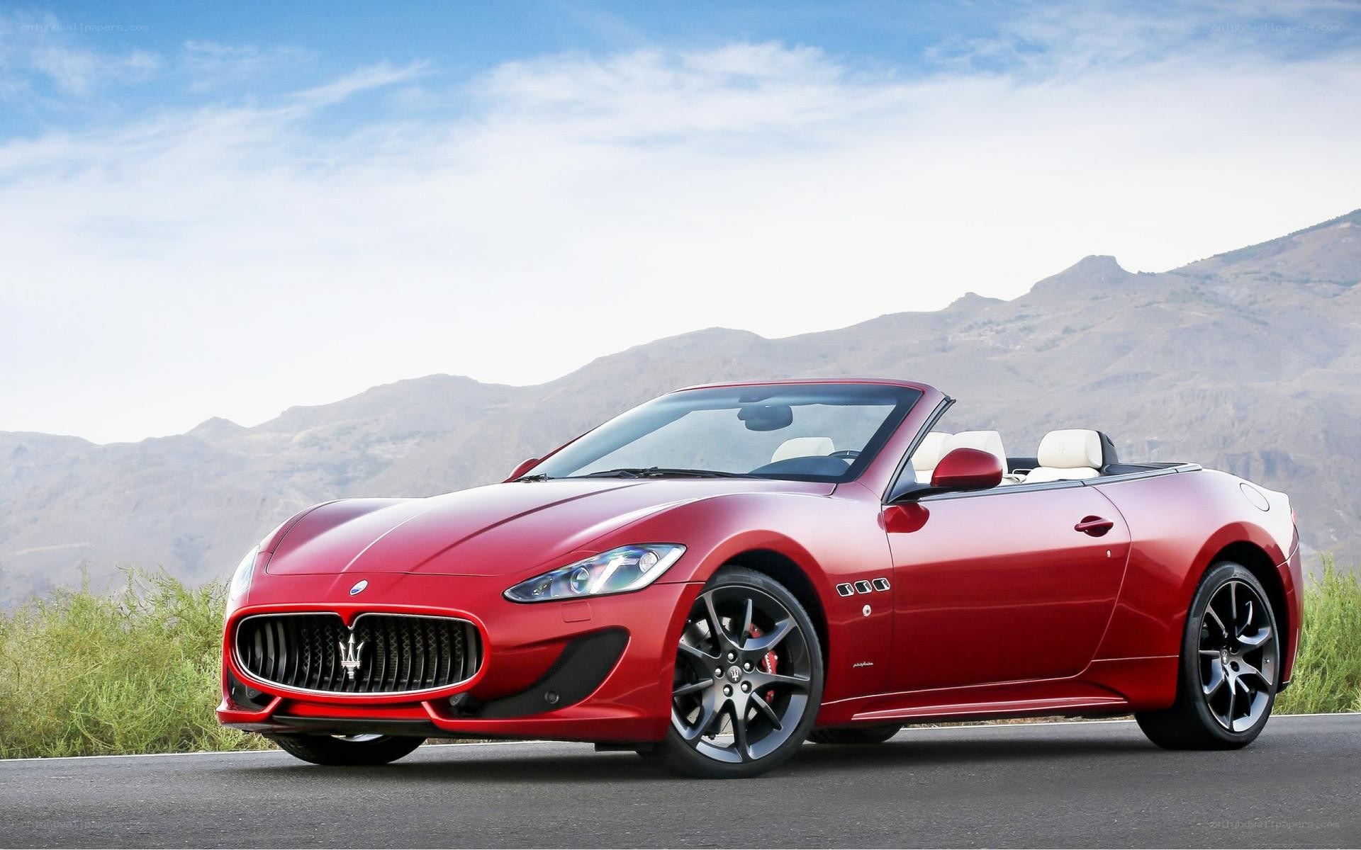 Red Maserati convertible on mountain road