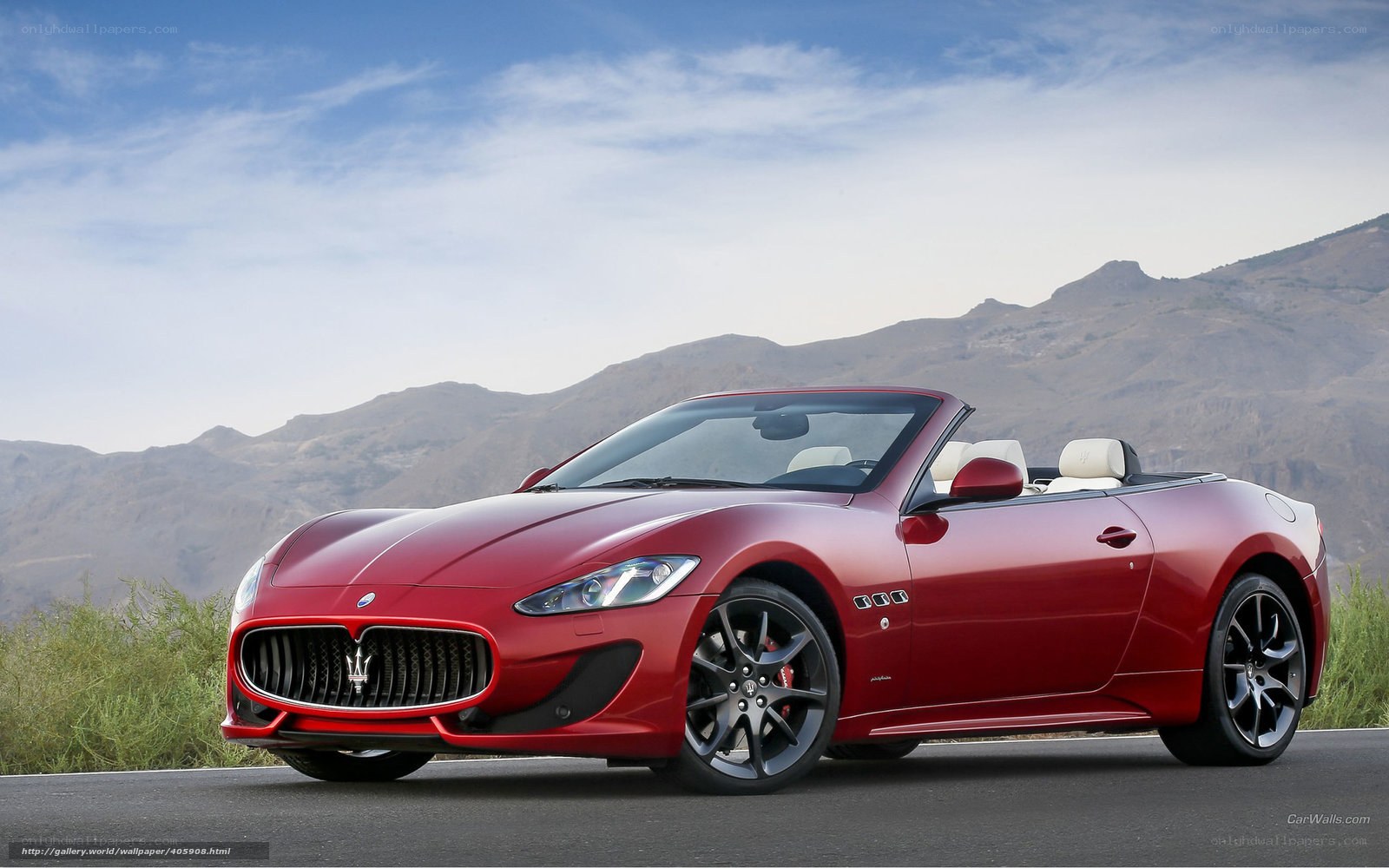 Red Maserati convertible on mountain road