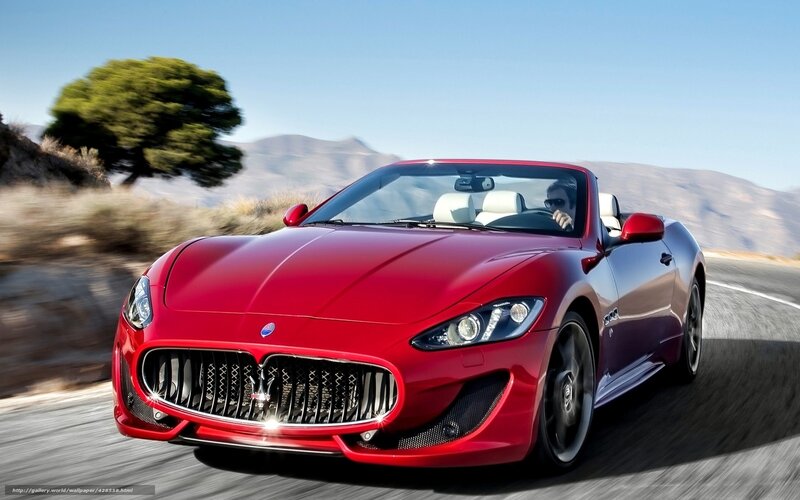 Red Maserati convertible on road