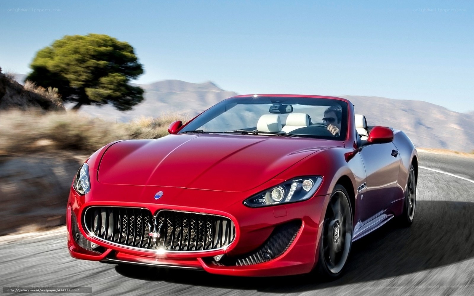 Red Maserati convertible on road