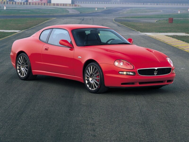 Red Maserati coupe on racetrack