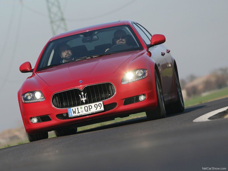 red maserati driving on road