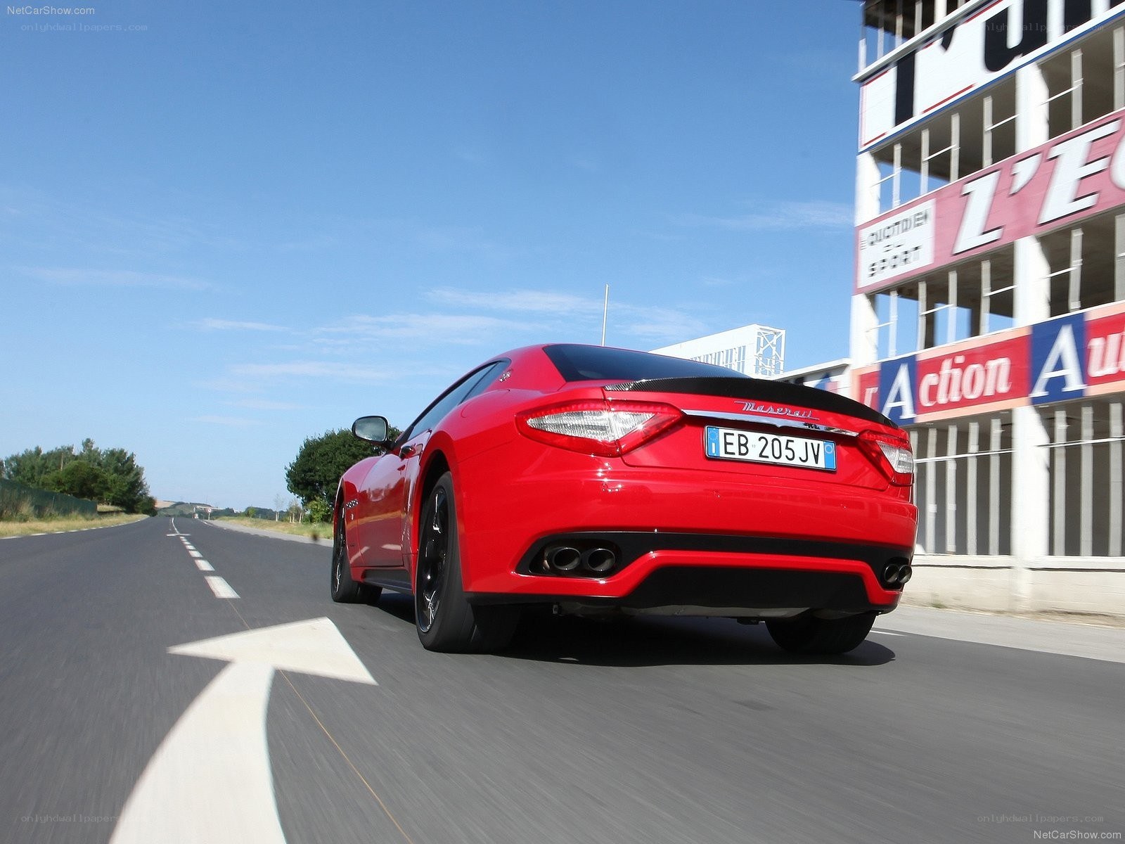 Red Maserati driving on track