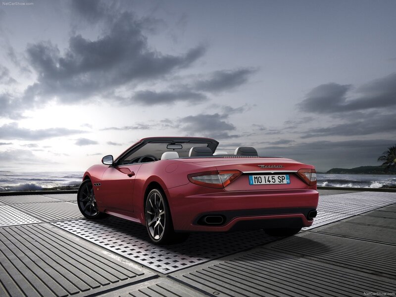 Red Maserati GranCabrio parked by the sea
