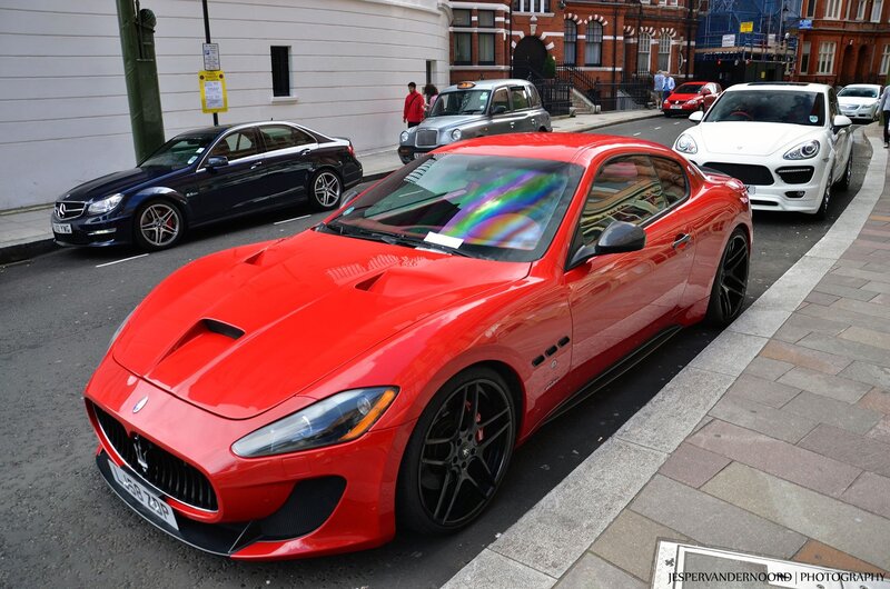 Red Maserati on city street