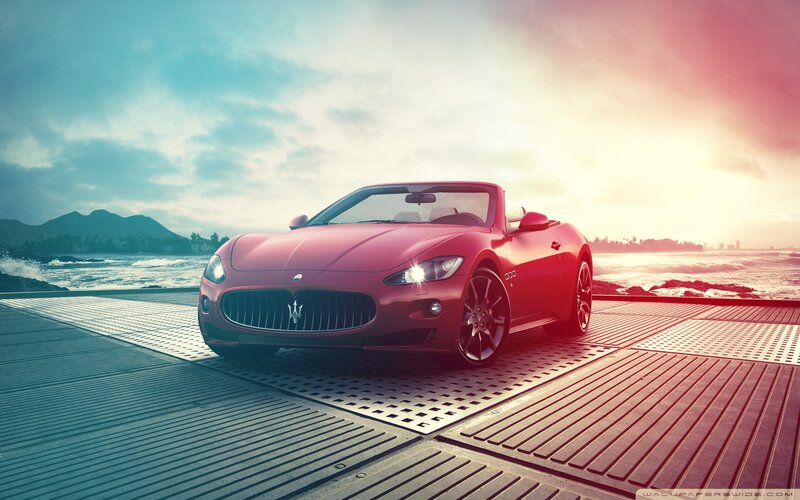 Red Maserati on coastal pier