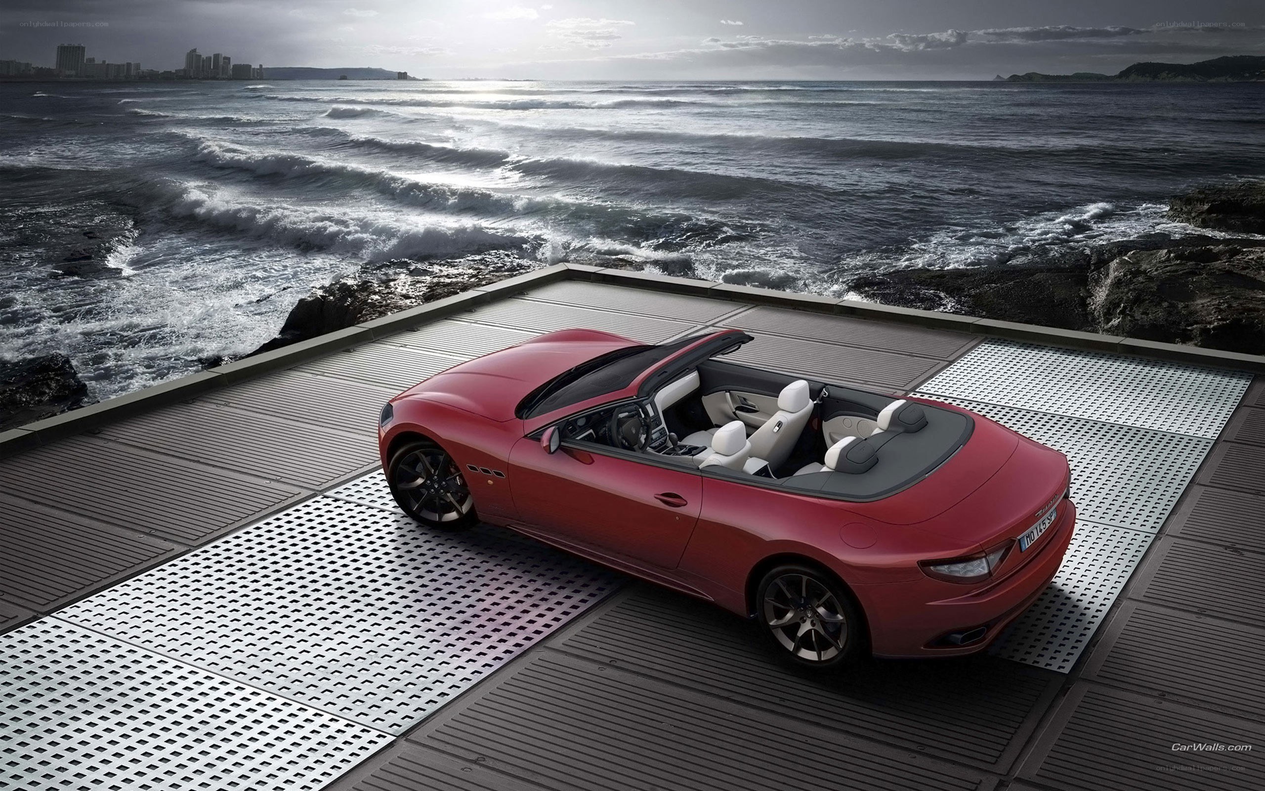 Red Maserati on coastal platform