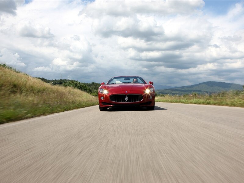 Red Maserati on country road
