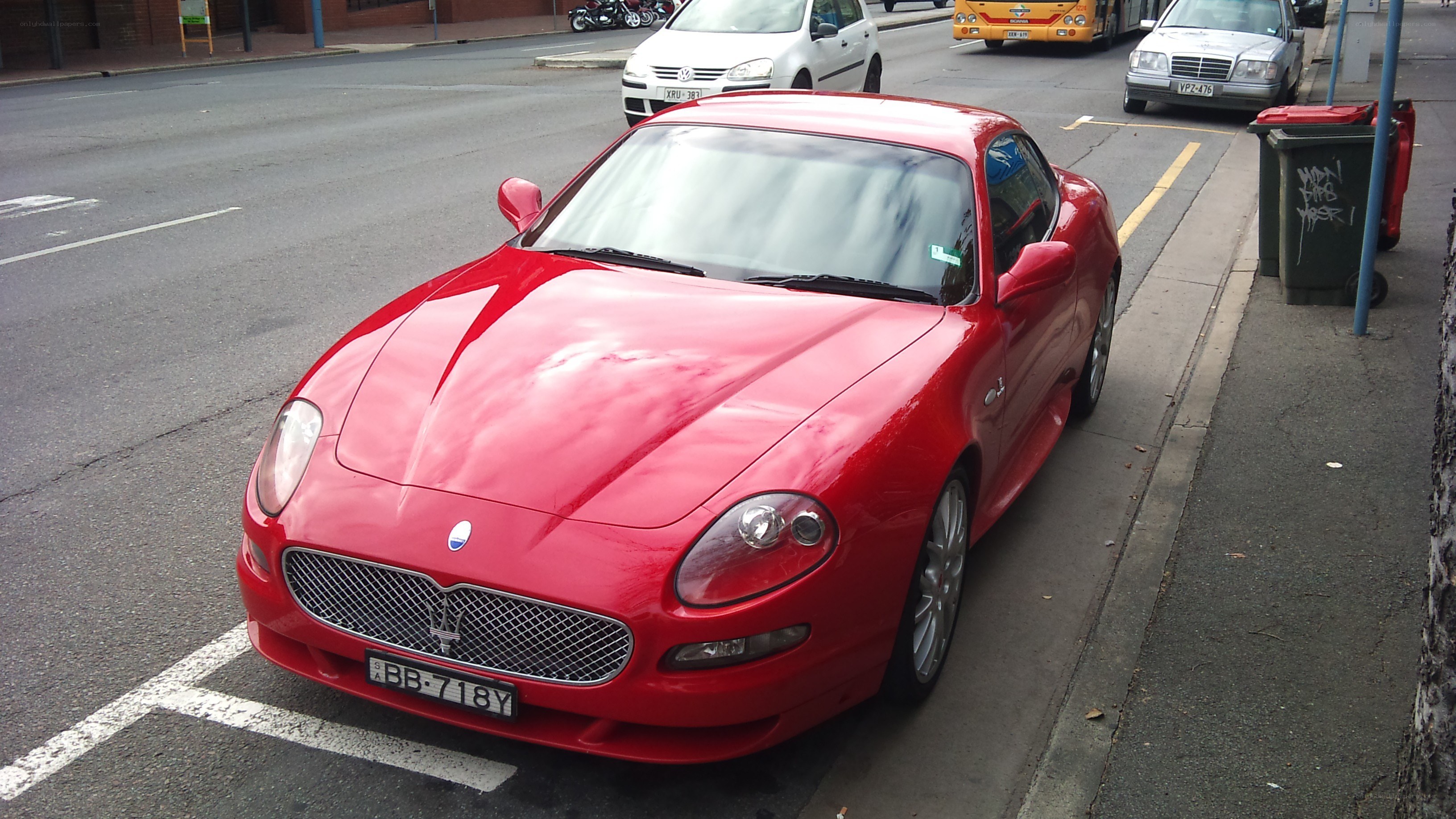 Red Maserati parked on street