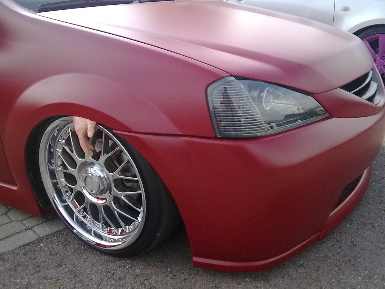 red matte car with custom wheels