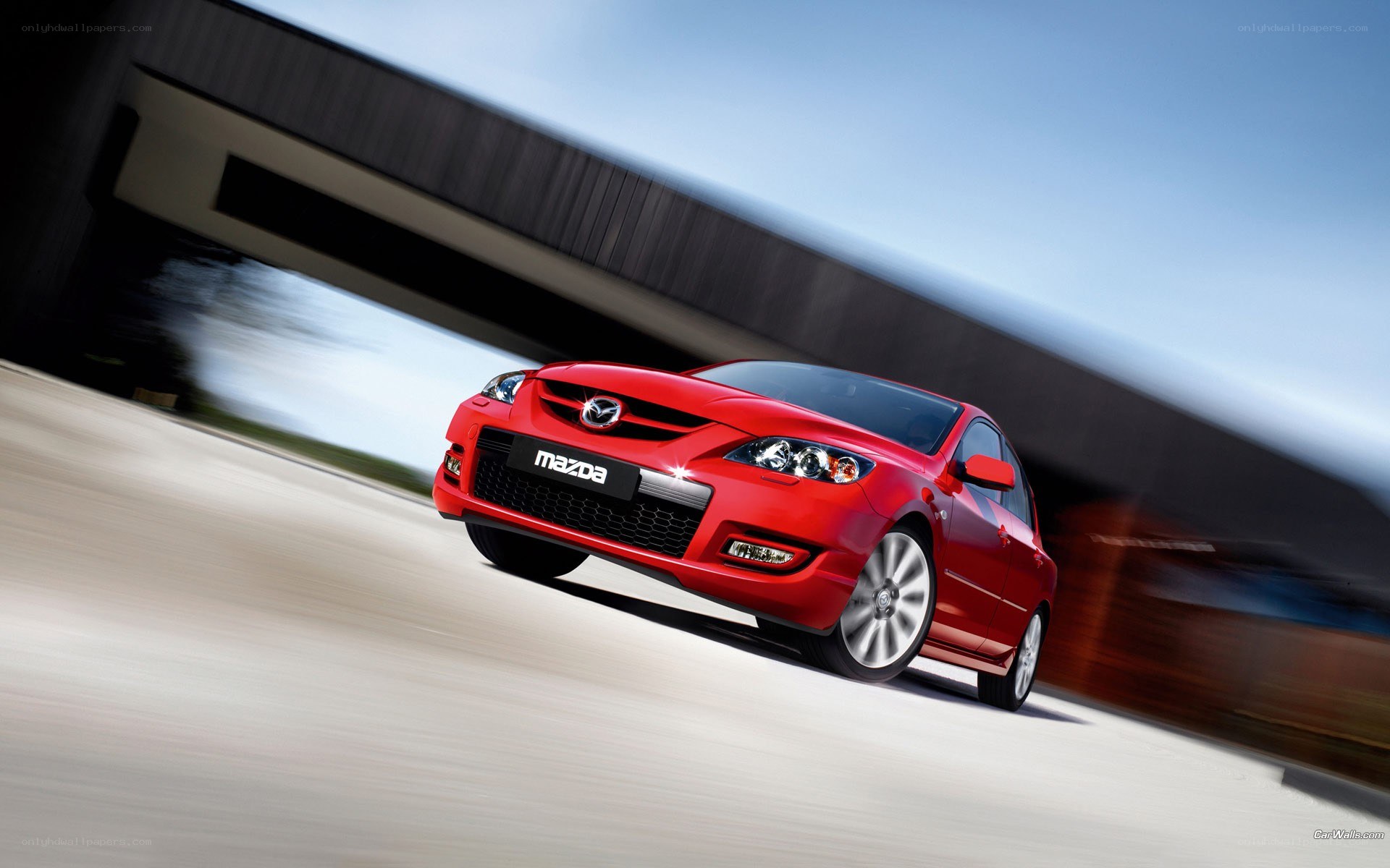 Red Mazda 3 in motion