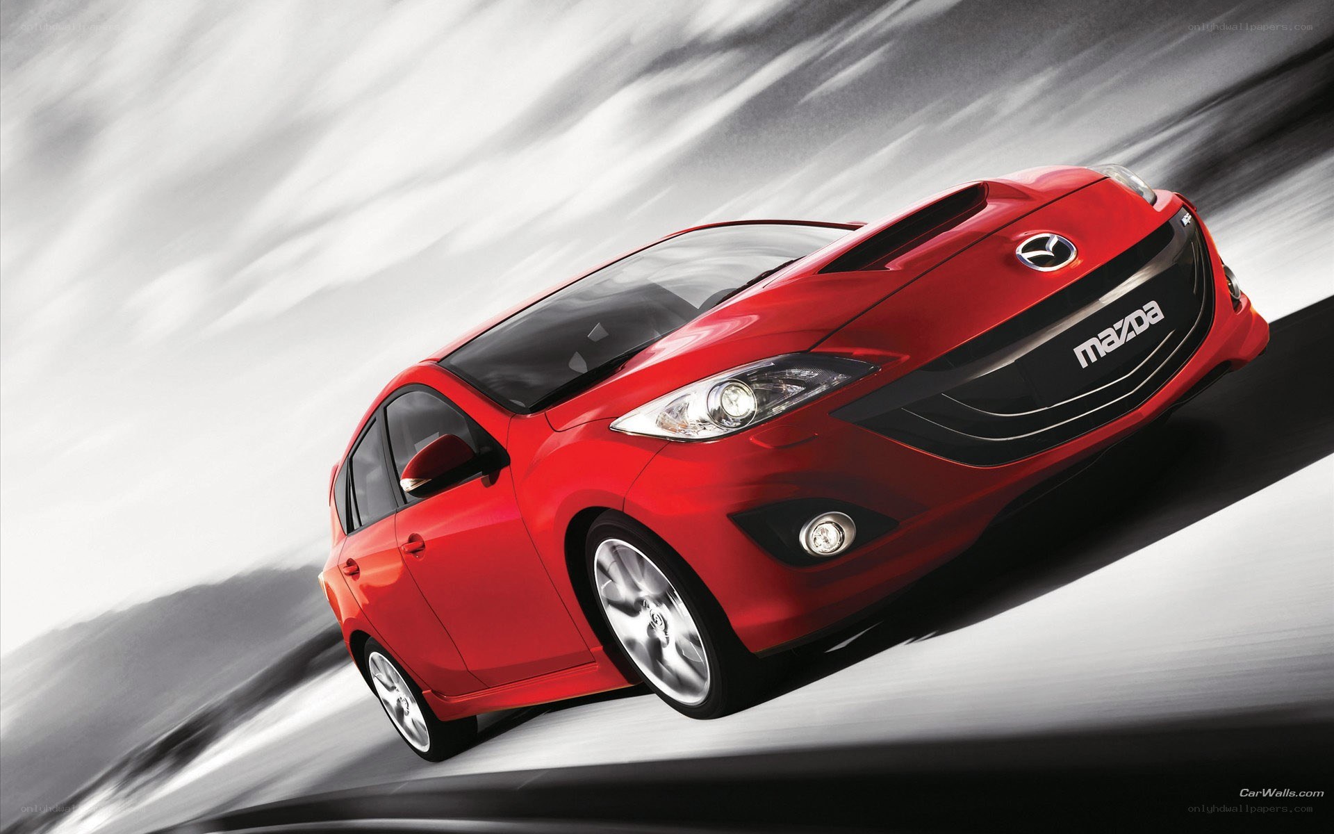 Red Mazda 3 in motion