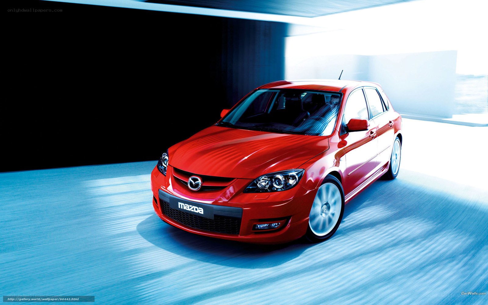Red Mazda 3 in motion