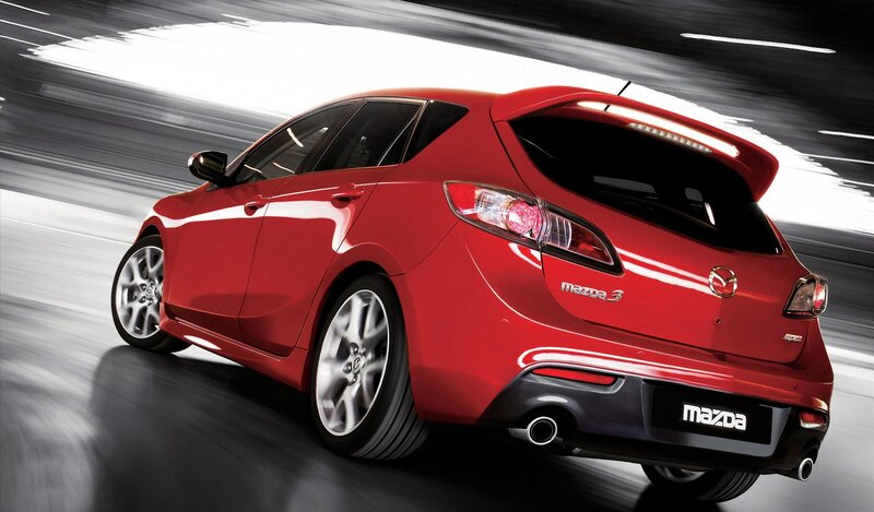 Red Mazda 3 in motion