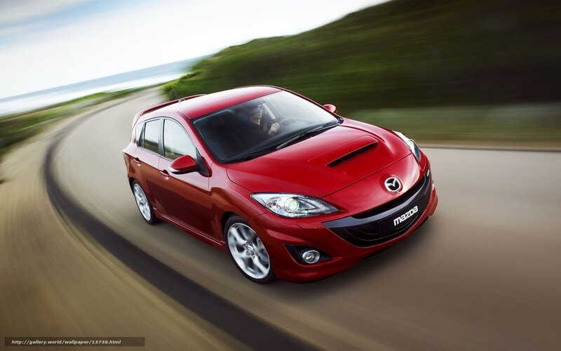 Red Mazda 3 in motion