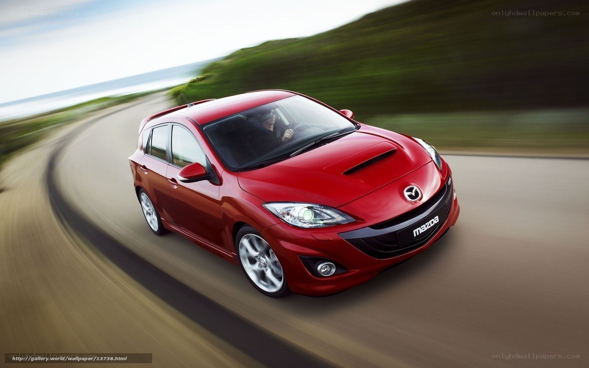 Red Mazda 3 in motion