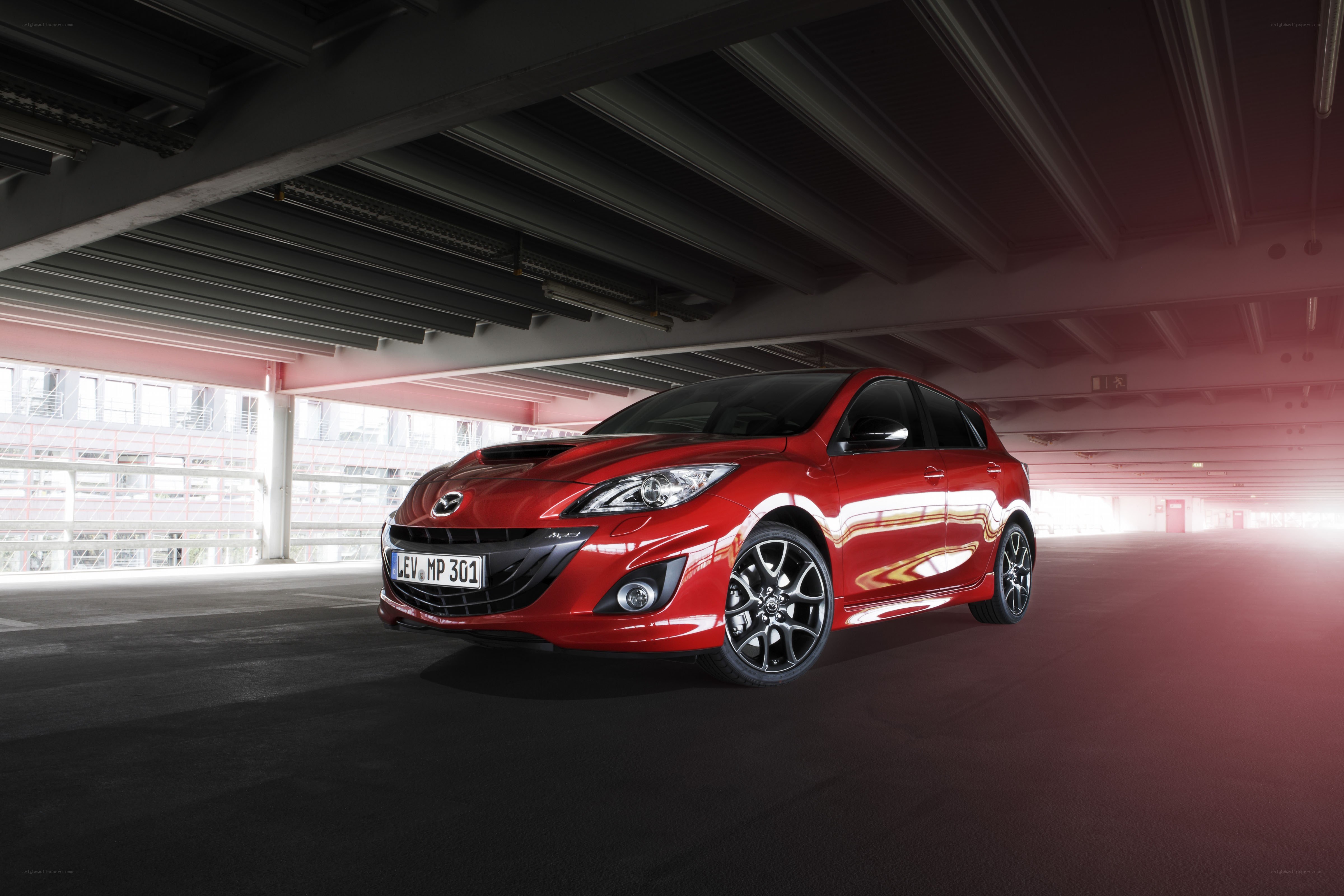 Red Mazda 3 in parking garage