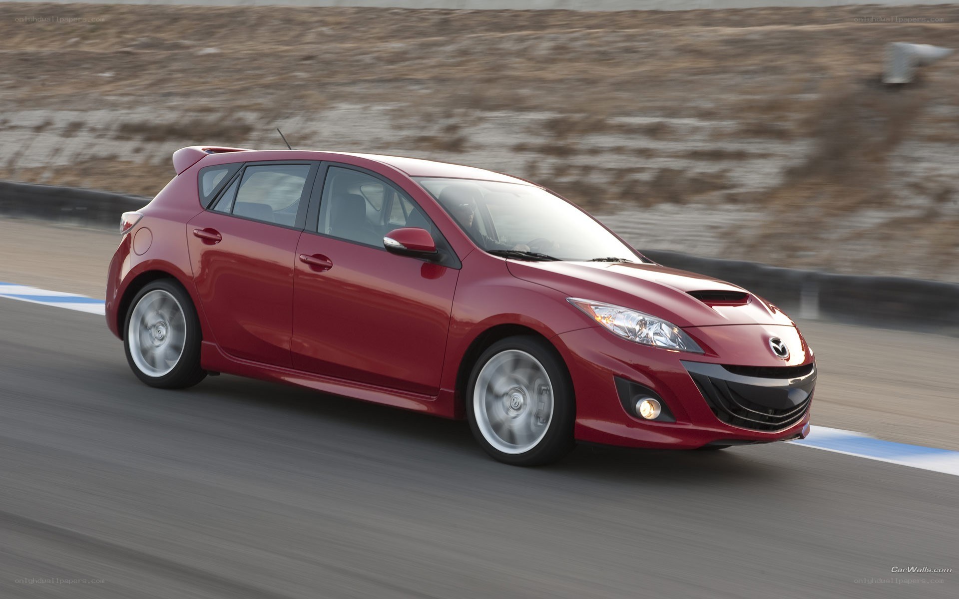 red mazda 3 on a racetrack