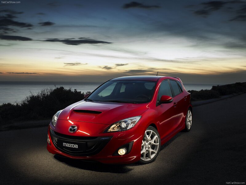 Red Mazda 3 on coastal road