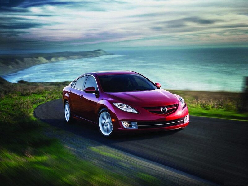 Red Mazda 6 on coastal road