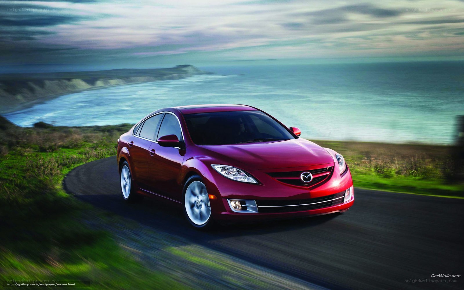 Red Mazda 6 on coastal road