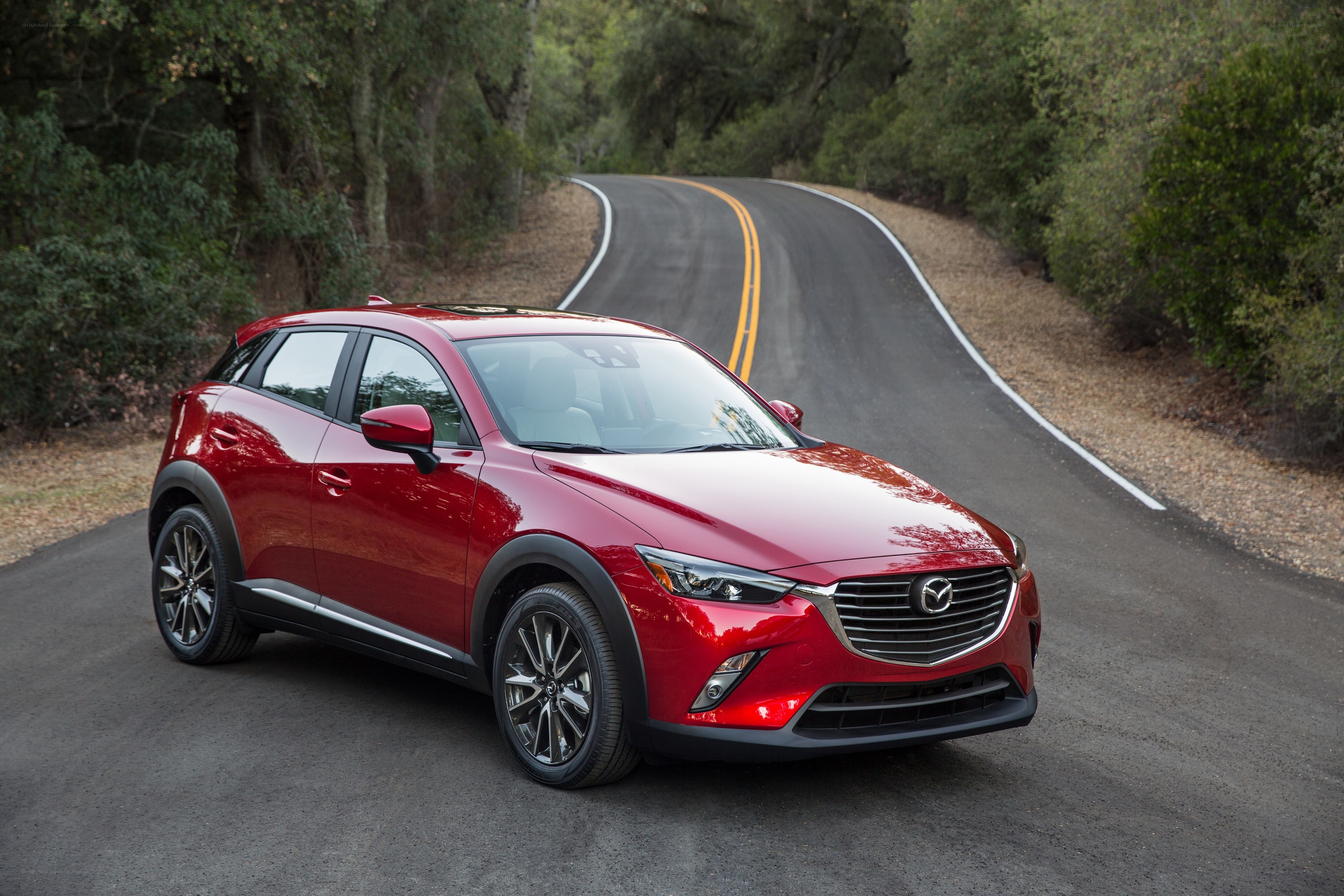 Red Mazda CX-3 on a winding road