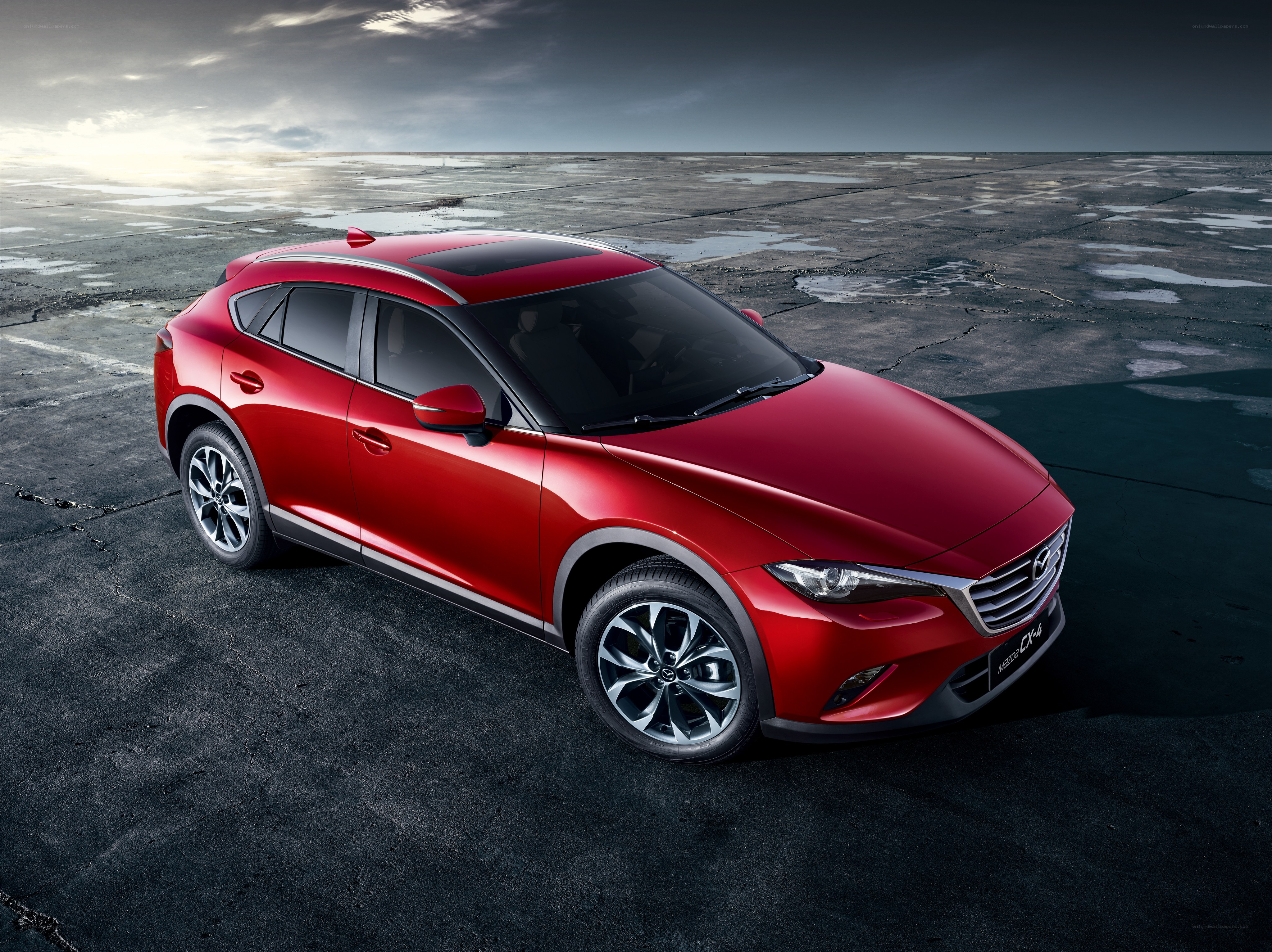 Red Mazda CX-4 on wet pavement