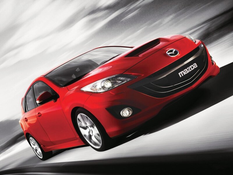 Red Mazda hatchback in motion