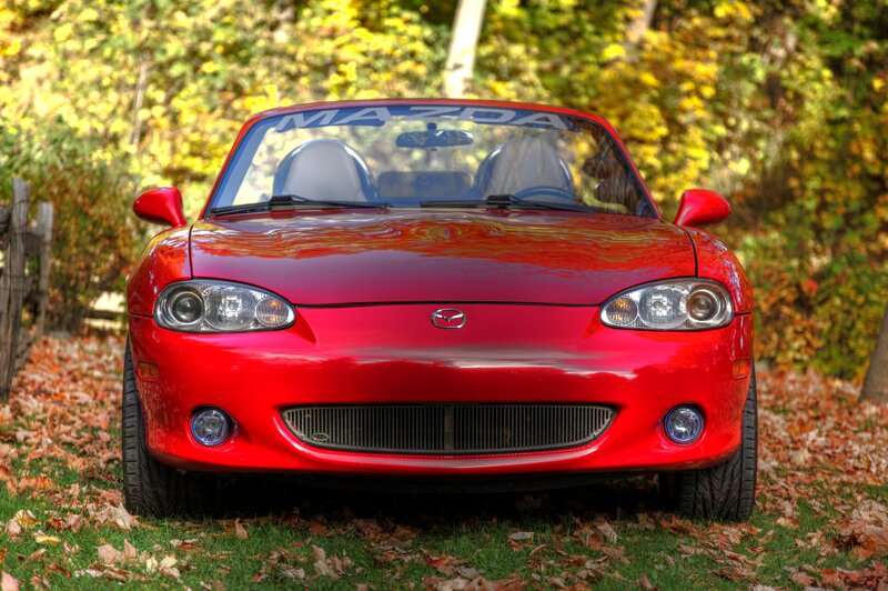 Red Mazda Miata in autumn