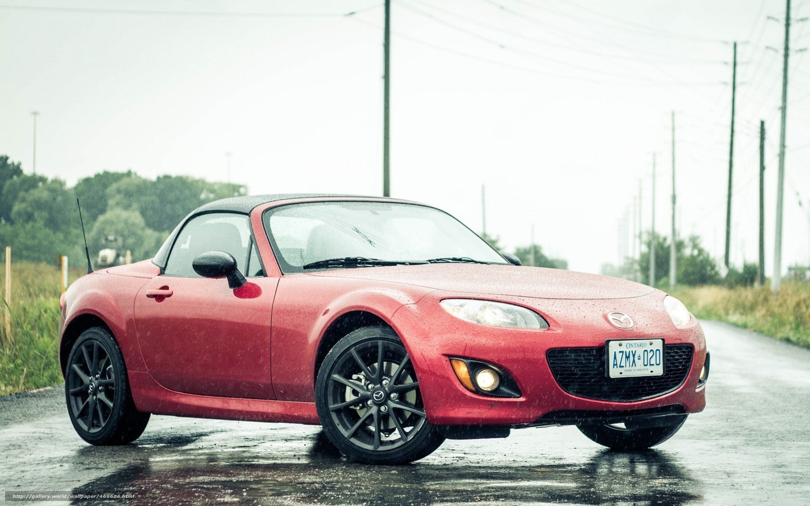 Red Mazda Miata in the rain