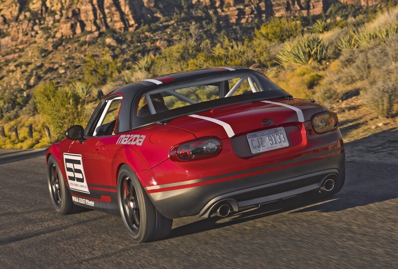 Red Mazda Miata race car on road