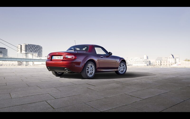 Red Mazda MX-5 parked on pavement