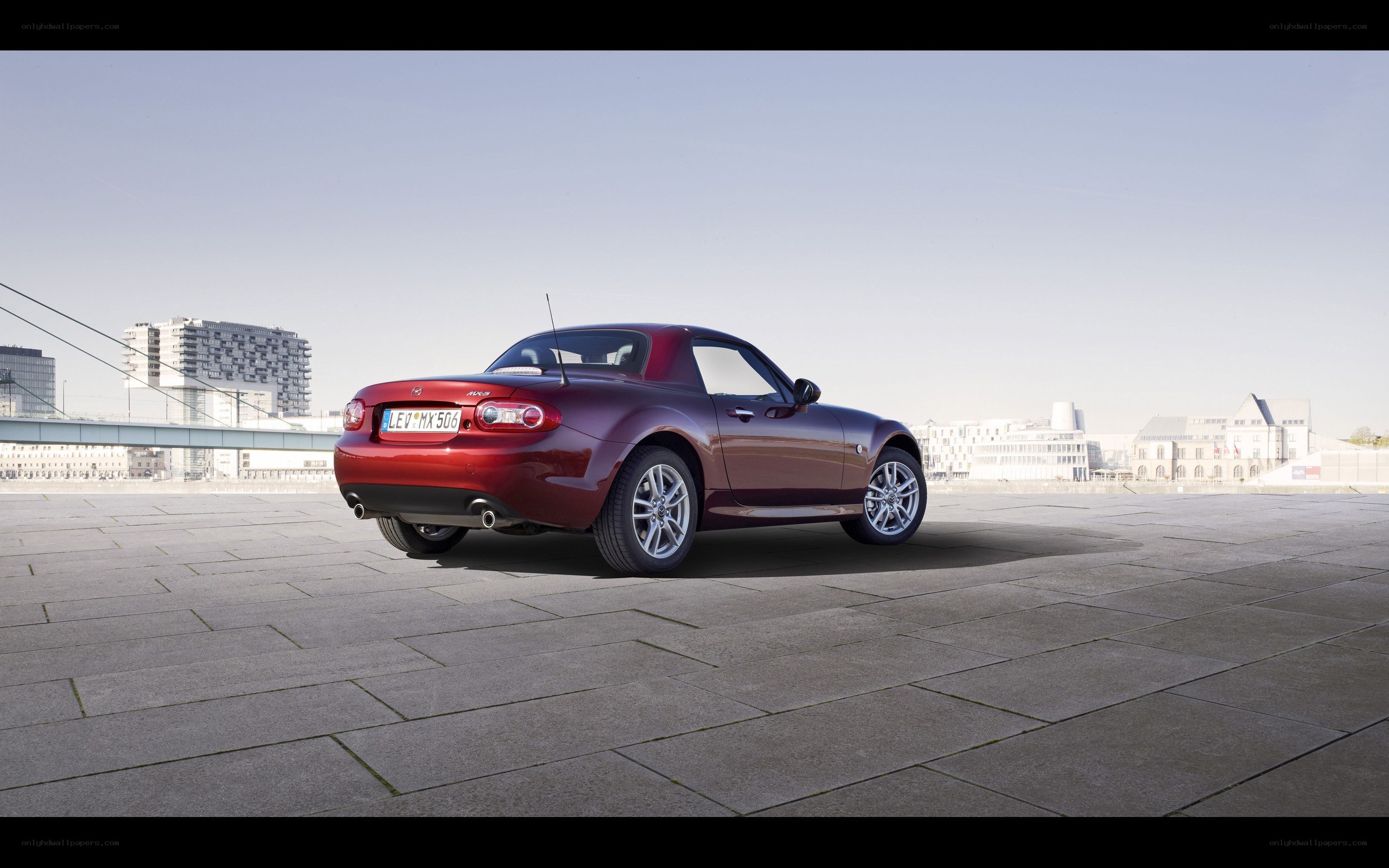 Red Mazda MX-5 parked on pavement