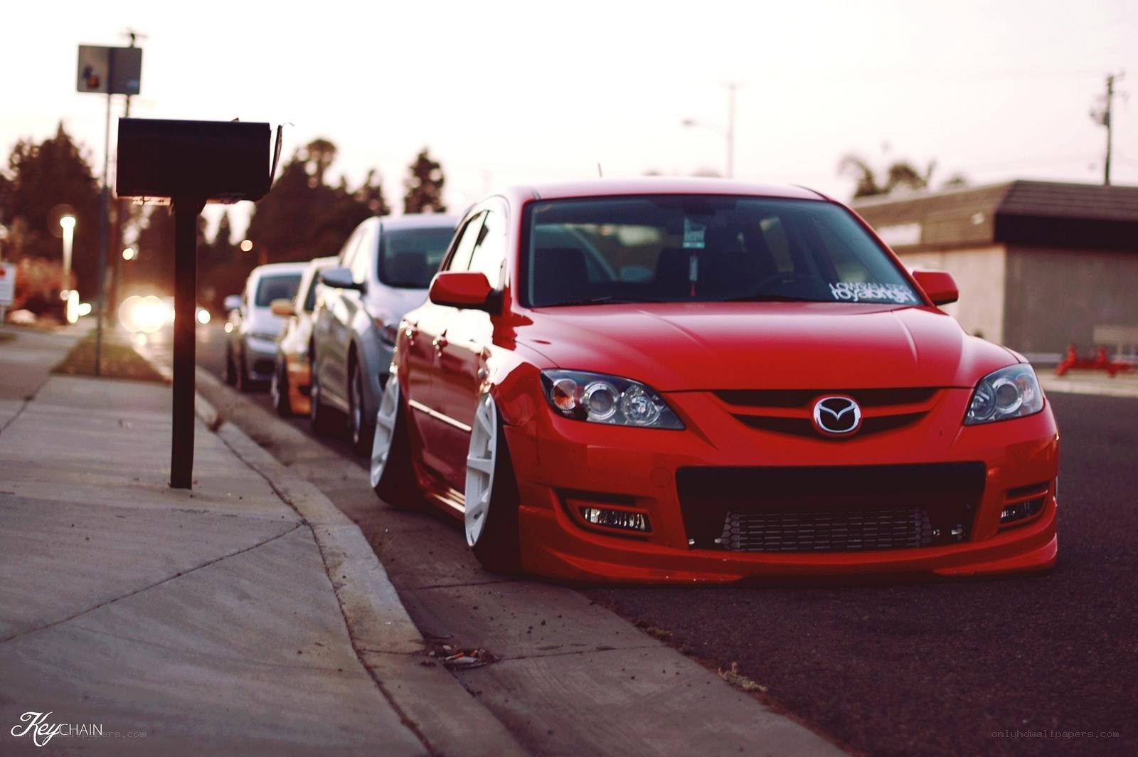 Red Mazda parked on street