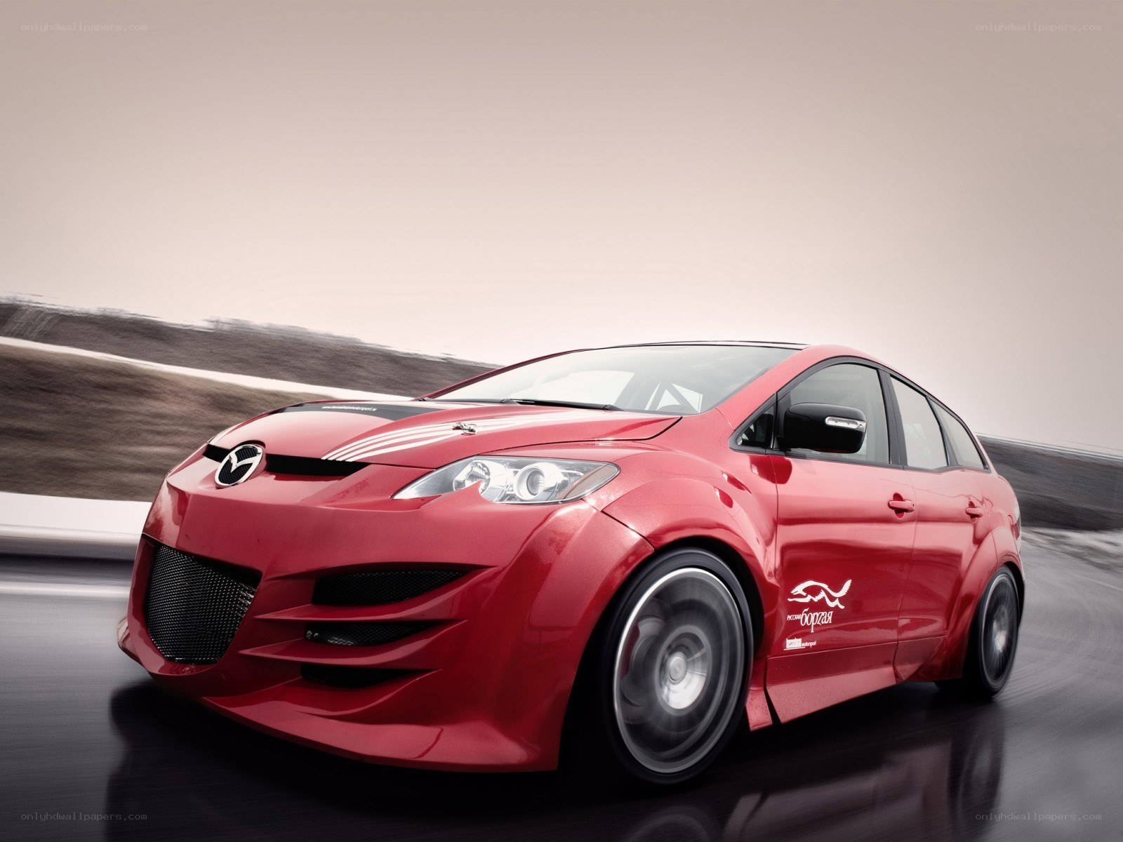 Red Mazda race car in motion