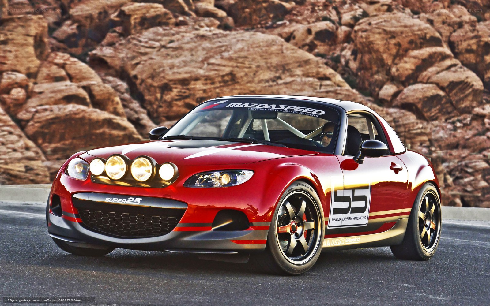 Red Mazda race car on desert road