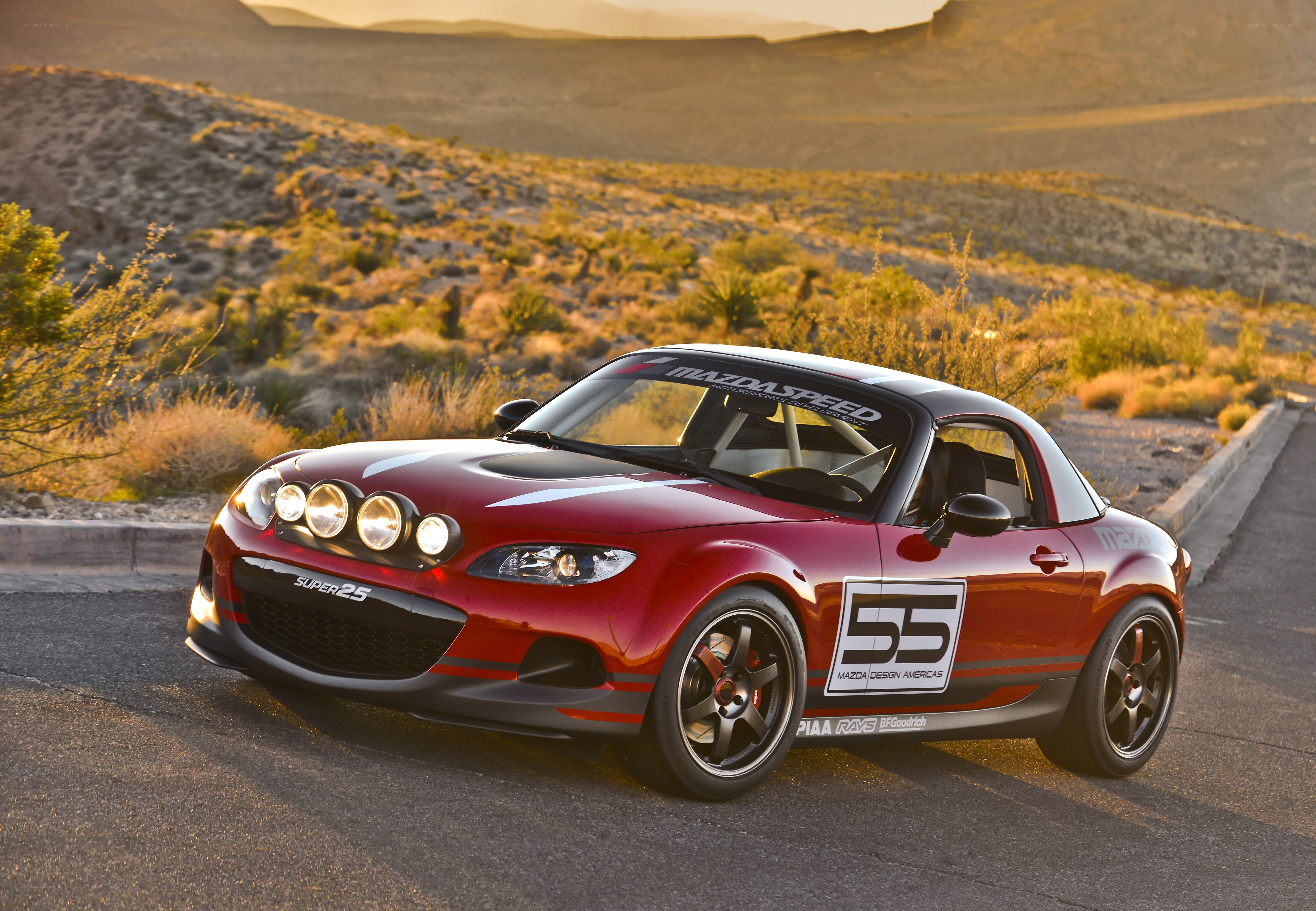 Red Mazda roadster in desert