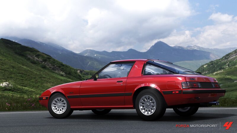 Red Mazda RX-7 in mountain scenery