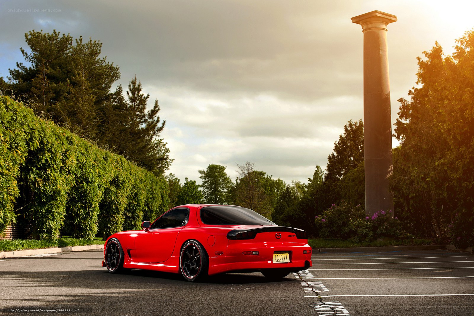 Red Mazda RX-7 in parking lot