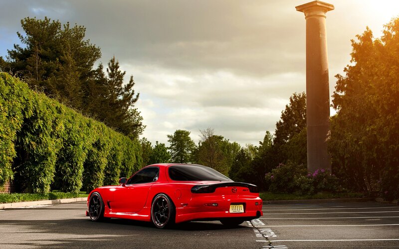 Red Mazda RX-7 in parking lot
