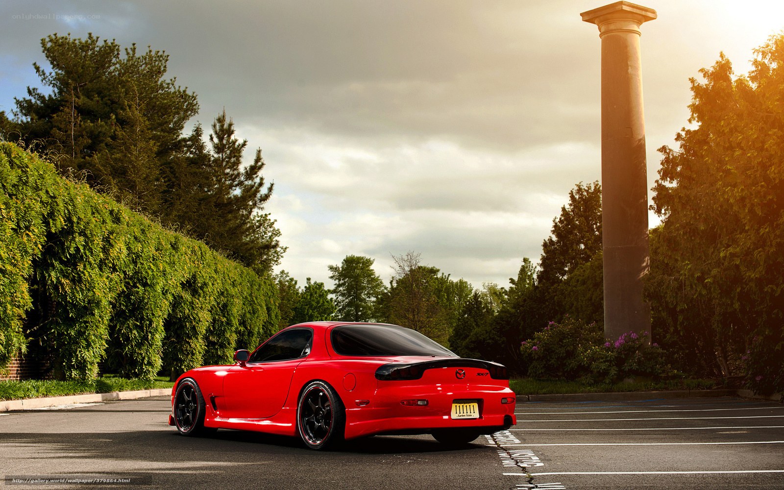 Red Mazda RX-7 in parking lot