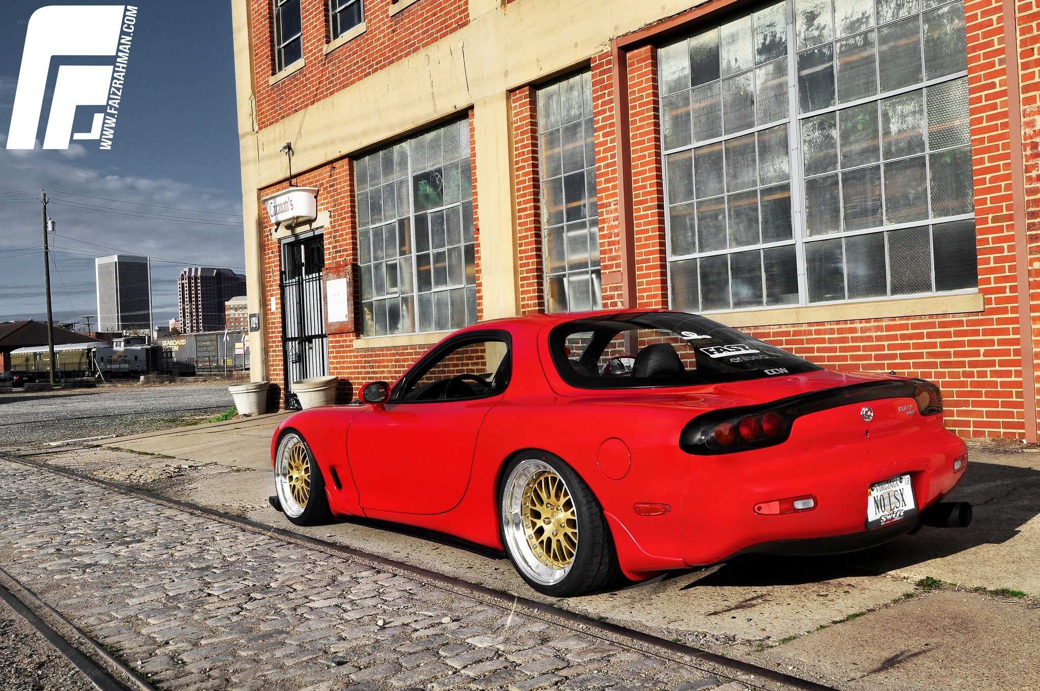 Red Mazda RX-7 in urban setting