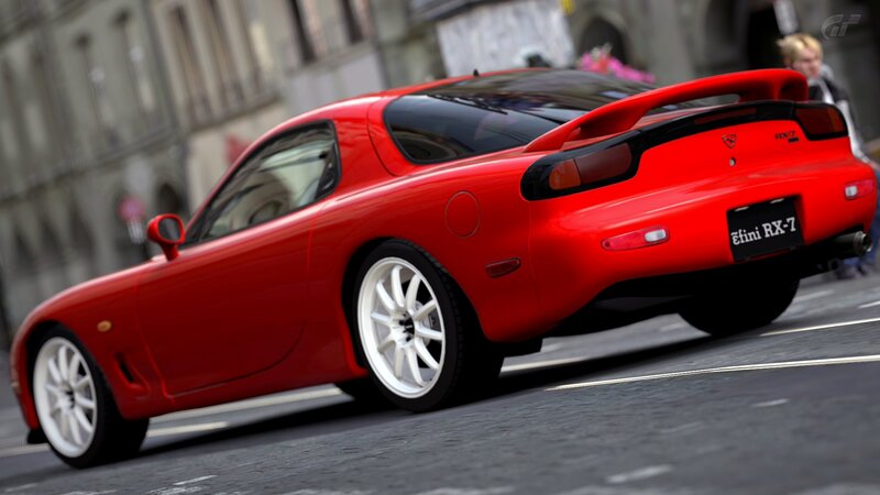 Red Mazda RX-7 on city street