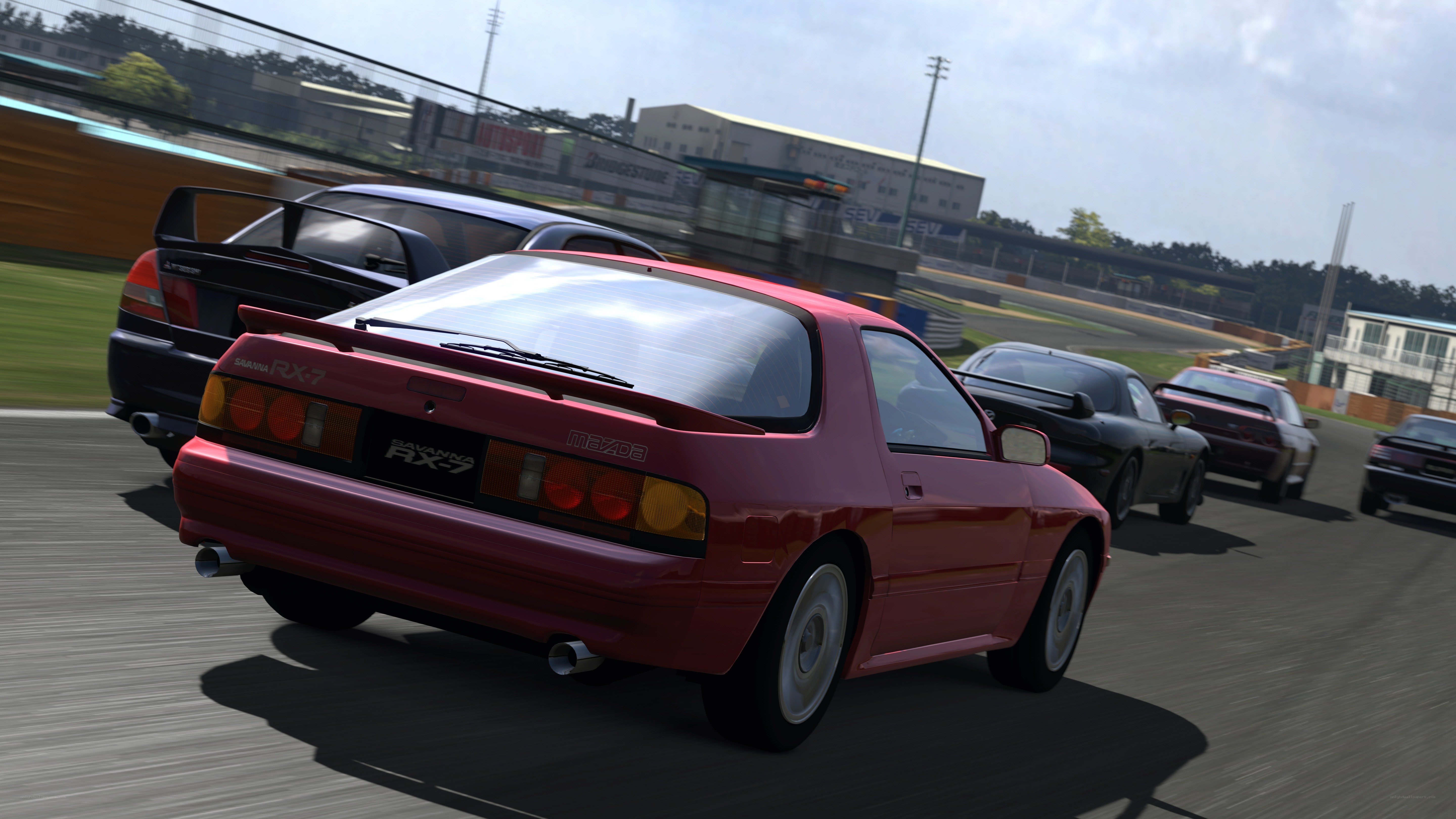 Red Mazda RX-7 racing on track