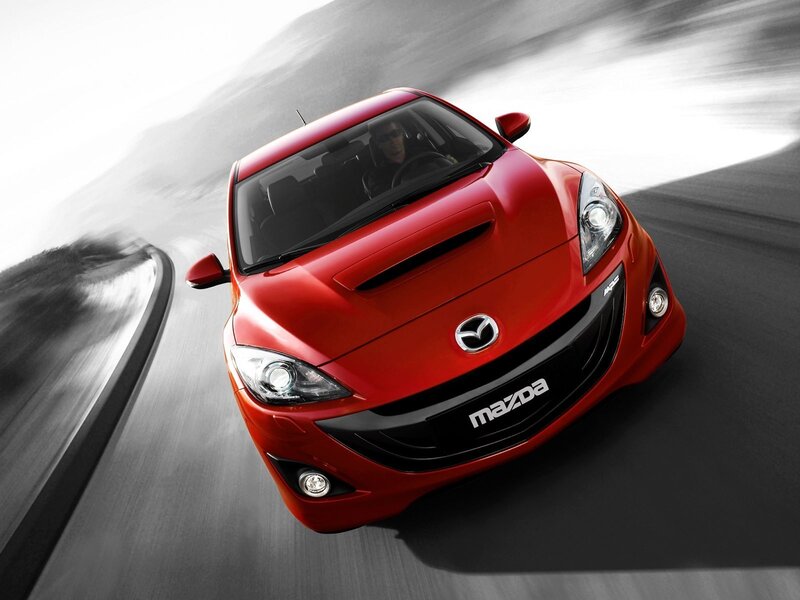 Red Mazda sports car in motion