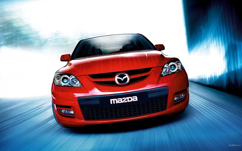 Red Mazda sports car in motion