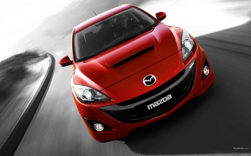 Red Mazda sports car in motion