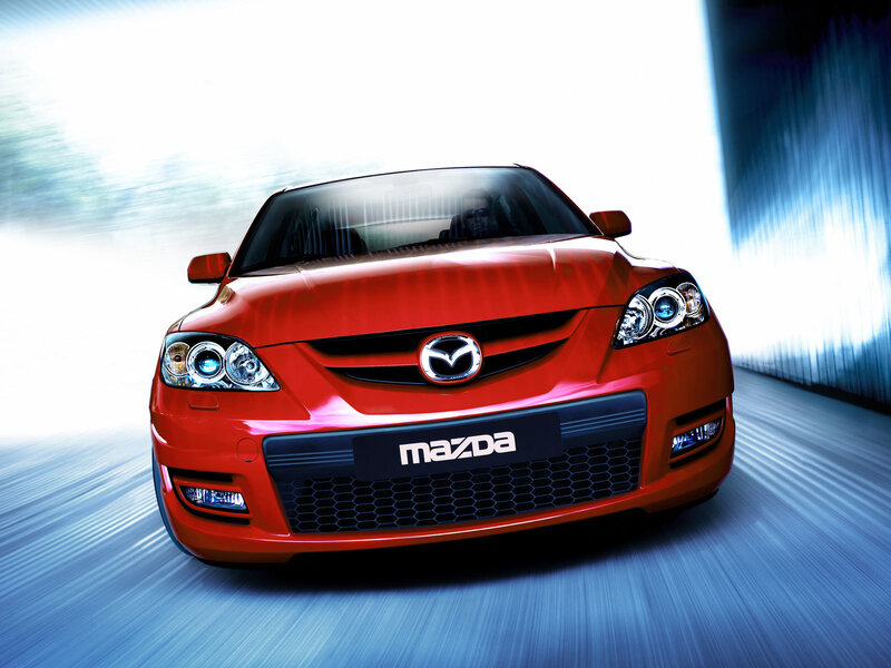 Red Mazda sports car in motion