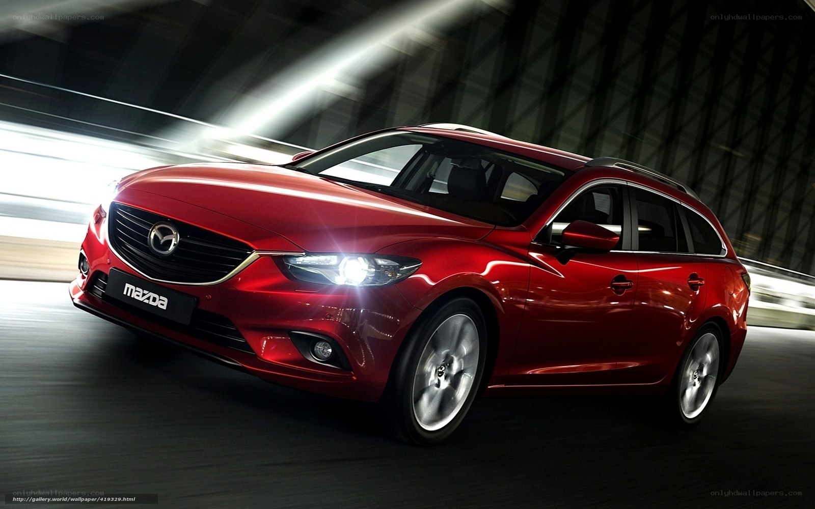 Red Mazda station wagon in motion