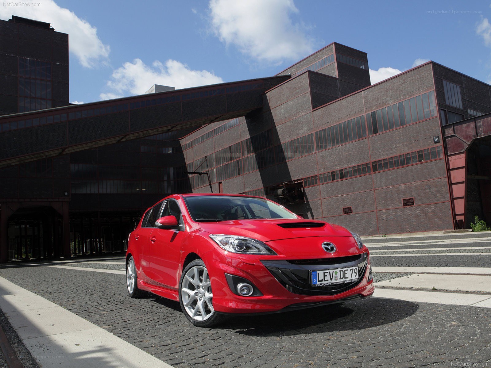 Red Mazda3 in industrial setting